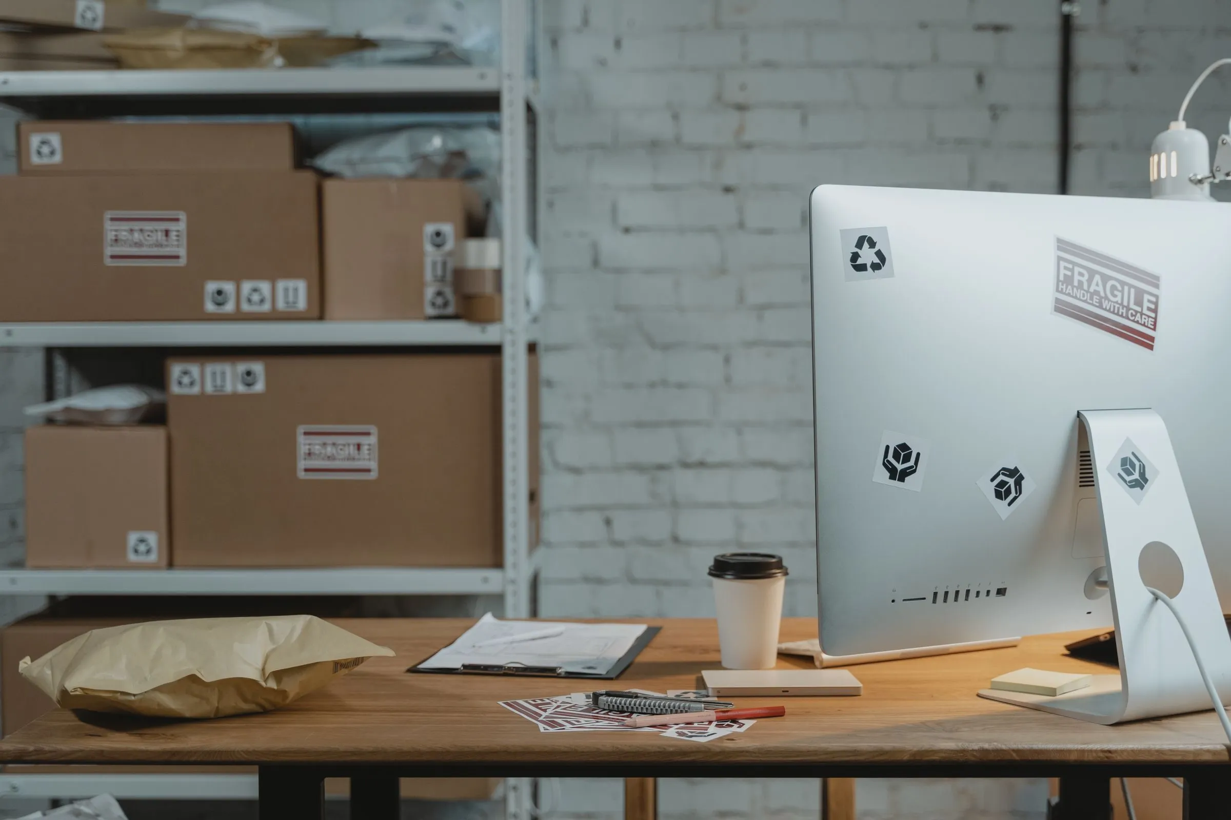 Desk with a computer, coffee and parcels