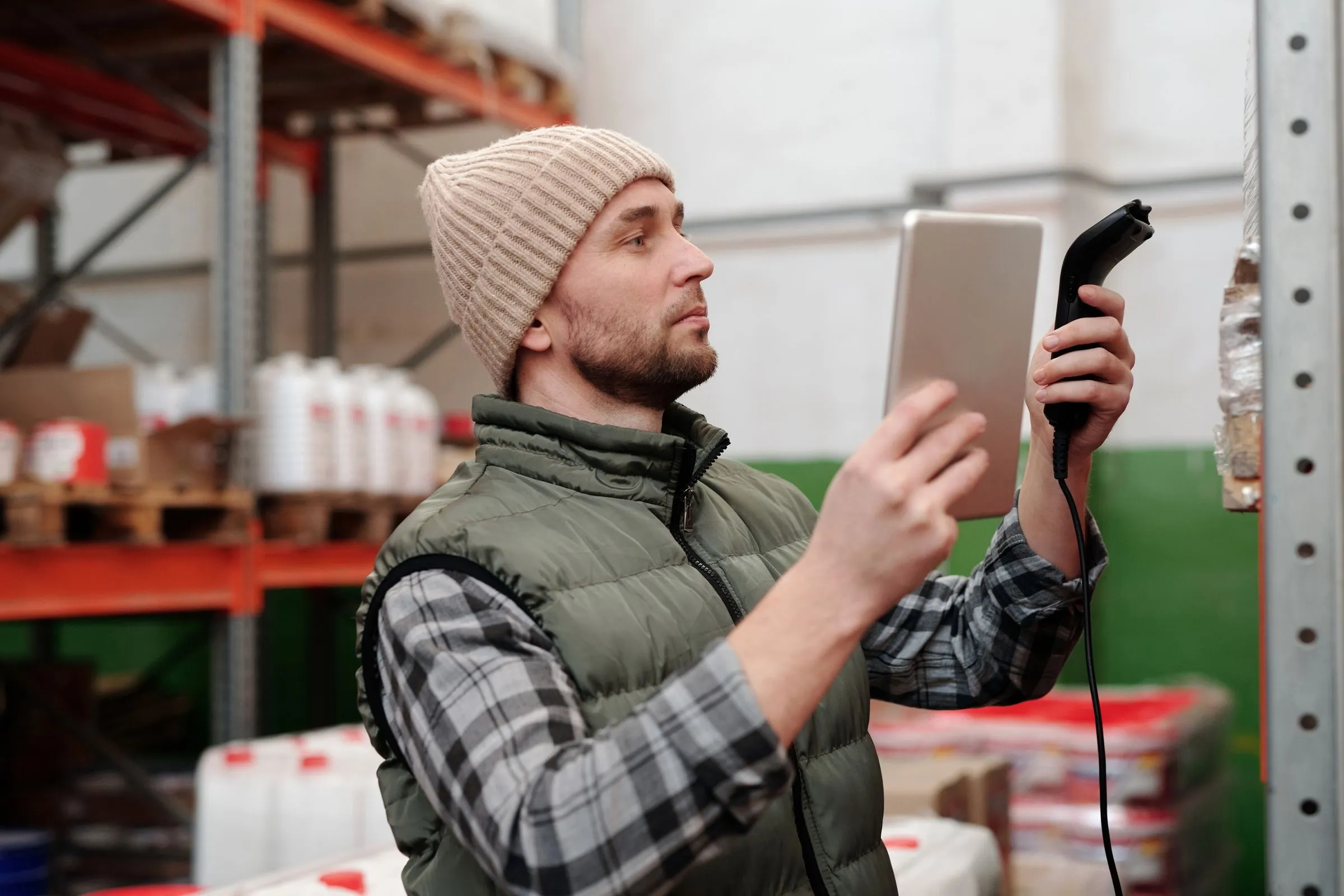 Warehouse worker with a tablet and scanner during stocktaking